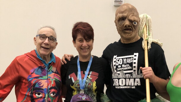 Troma founder and president Lloyd Kaufman with KPBS arts reporter Beth Accomando, Toxie, and Kristy Rose. July 25, 2025