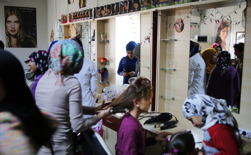 Syrian women take a free course on hairdressing at the Elbeyli Refugee Camp on Turkey's southern border with Syria. Administrators say the camp costs the Turkish government $3 million per month to run.