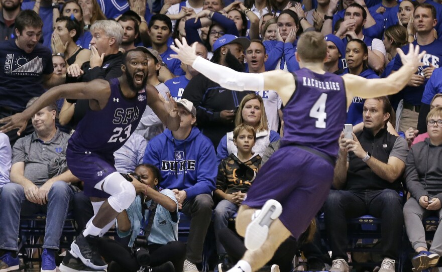 Stephen F. Austin forward Nathan Bain (23) and guard David Kachelries (4) celebrate Bain's game-winning shot against Duke in overtime Tuesday in Durham, N.C.