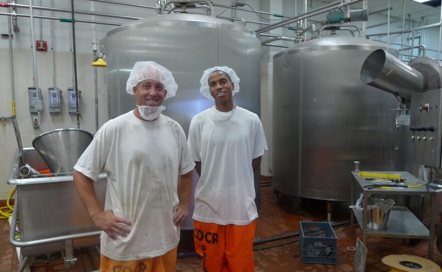 Inside the secure perimeter in the milk processing facility at Corcoran state prison, Ryan Mons (left) and Edward Wilson give a tour. Wilson's job involves testing the milk for bacteria. "I take pride in what I do," he says.