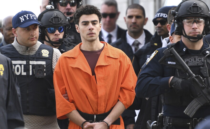 Luigi Mangione, a suspect in the fatal shooting of UnitedHealthcare CEO Brian Thompson, is escorted by police on Dec. 19, 2024, in New York.