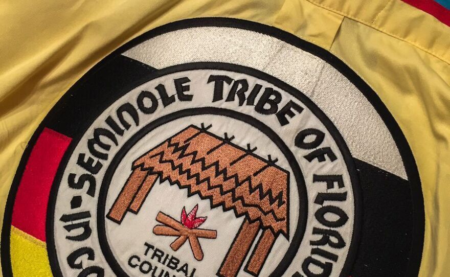 The official seal of the Seminole Tribe of Florida, in medicine colors of black, yellow, white and red.