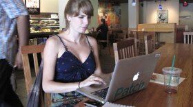 Lauren Evans, a Patch editor, works on her laptop at a Starbucks in College Park, Md. She says she works "pretty much anywhere" -- from bagel shops to the curb outside of a fire station.
