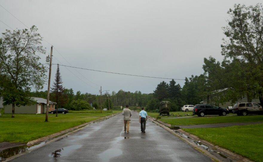 James Rees, left, and Nicholas Pinter of the University of California, Davis, gather housing data in the town of Odanah, Wis.