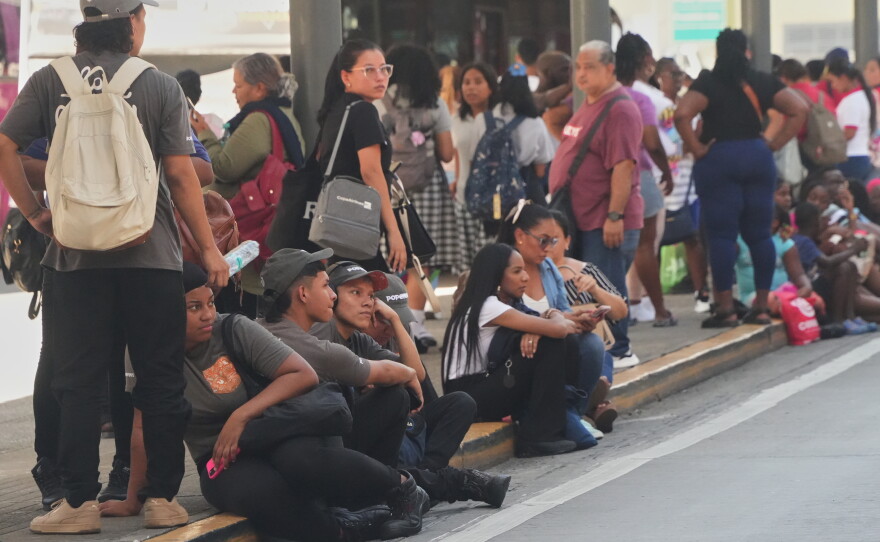 People gather outside shopping mall after an earthquake hit Panama City, Friday, Oct. 9, 2026.