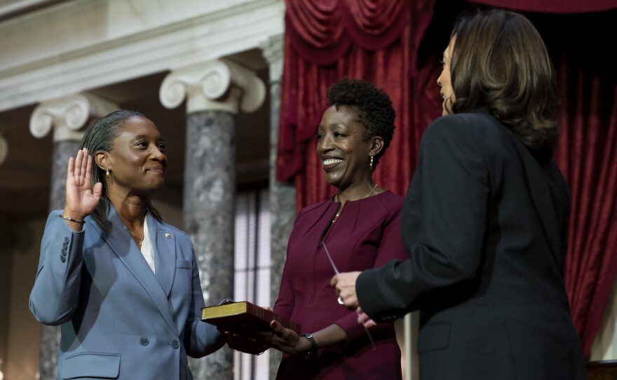 Vice President Kamala Harris, right, swears in Laphonza Butler, D-Calif., left, to the Senate to succeed the late Sen. Dianne Feinstein during a re-enactment of the swearing-in ceremony on Tuesday, Oct. 3, 2023, on Capitol Hill in Washington. Butler's wife, Neneki Lee, center, holds the Bible.