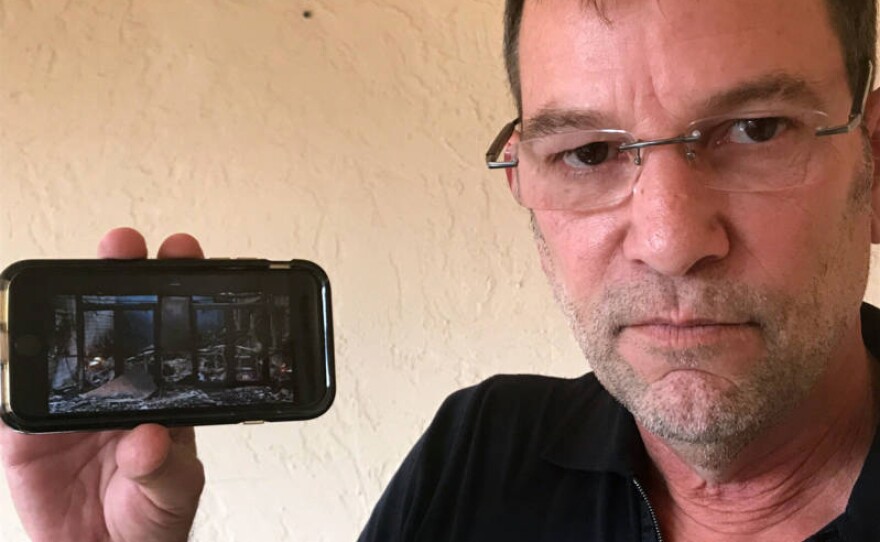 Andrew Bailey, CEO of Anova school, holds a cellphone with a photo of the facility, which was destroyed by the Tubbs Fire this week in Santa Rosa, Calif.