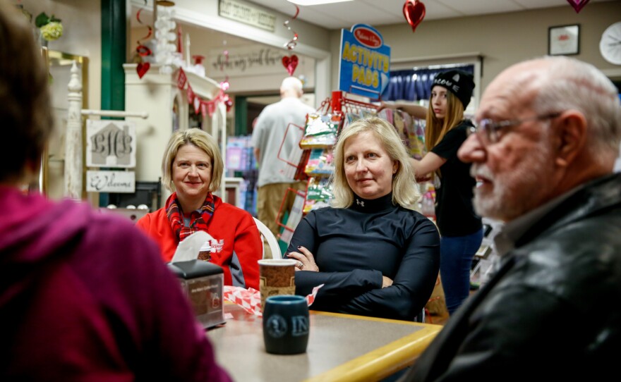 Sarah Wilson and Kym Kays chat with friends at Ane Mae's coffee shop. "We do express our opinions, but then we kind of back away politely," says Wilson. "We are Kansas polite! We are a Kansas polite community!" adds Kays.