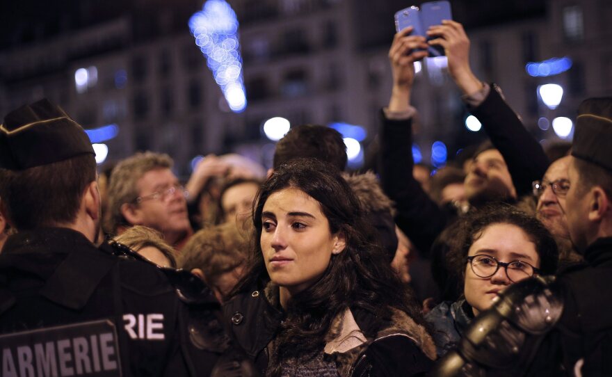 People paying tribute to victims in front of HyperCacher supermarket at Porte de Vincennes, a day after a gunman took hostages and opened fire.