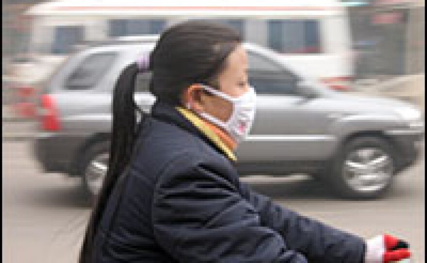 Residents of Linfen in Shanxi province wear masks to protect themselves from the air they breathe. By some official calculations, the death rate here is 10 times higher than China's normal mortality rate.