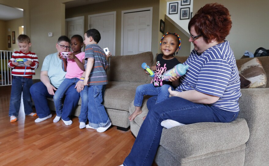 Jayne Rowse (left) and April DeBoer at home with their four children in Hazel Park, Mich. Because Michigan will not allow a same-sex couple to adopt, but will let a single person adopt, Jayne has adopted two of the children and April the other two.