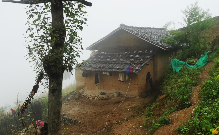 The Mose family lives in a mud-brick farmhouse in Atule'er village, a poor, isolated community of 72 ethnic Yi families atop a mountain in southwest China's Sichuan Province.
