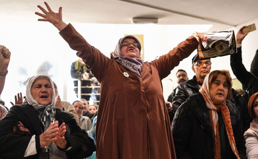 People celebrate as they watch a live TV broadcast on Wednesday in Srebrenica, when U.N. judges announce the life sentence in the trial of former Bosnian Serb commander Ratko Mladic, accused of genocide and war crimes in the brutal Balkans conflicts over two decades ago.