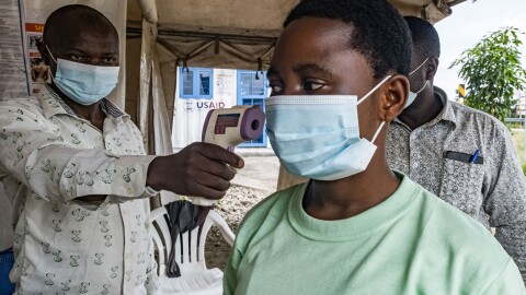 To keep Ebola from spreading in this current outbreak, a border health officer at the Busunga crossing between Uganda and the Democratic Republic of Congo checks a traveler's temperature using a contactless infrared thermometer on May 18.