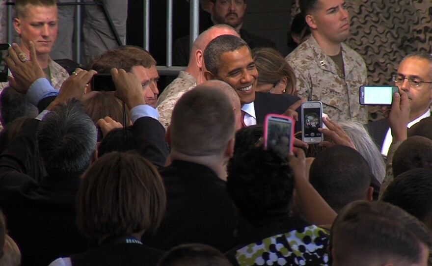 President Barack Obama poses for a picture with a Marine after his speech at Marine Corps Base Camp Pendleton on Wednesday, August 7, 2013, during his first visit to the base.