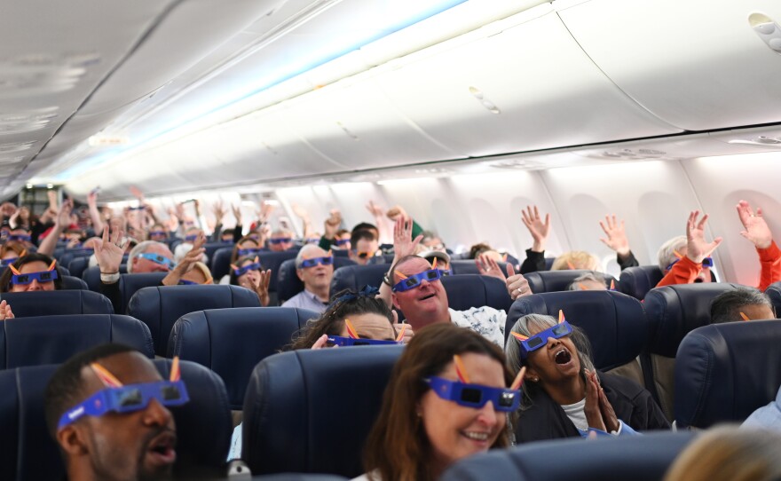 Passengers cheer as Southwest Flight 1910 departs highlighting the total solar eclipse from St. Louis to Houston, Texas at Lambert International Airport in St. Louis, Missouri.