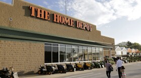 In this May 18, 2016, file photo, people approach an entrance to a Home Depot store in Bellingham, Mass. 