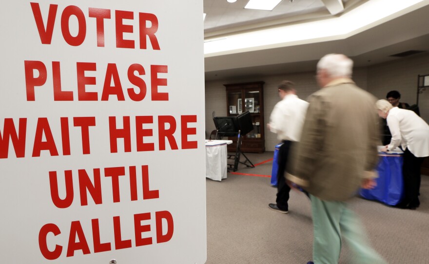 Voters are escorted to voting machines on Election Day Tuesday, Nov. 8, 2016, in Nashville, Tenn.