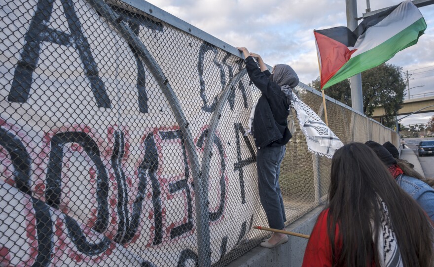 During the morning commute around two dozen proponents of a ceasefire in Gaza hung banners from a bridge overlooking the 5 North freeway at Nobel Drive in San Diego. The protesters waved Palestinian flags at drivers going North on the 5 Freeway, January 10, 2024.