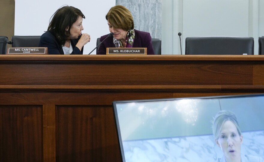 Sen. Maria Cantwell, D-Wash., top left, speaks with Sen. Amy Klobuchar, D-Minn., as Antigone Davis, Facebook's global head of safety, testifies virtually before the Senate Commerce, Science and Transportation Subcommittee on Consumer Protection, Product Safety and Data Security during a hearing on children's online safety and mental health, Thursday, Sept. 30, 2021, on Capitol Hill in Washington.