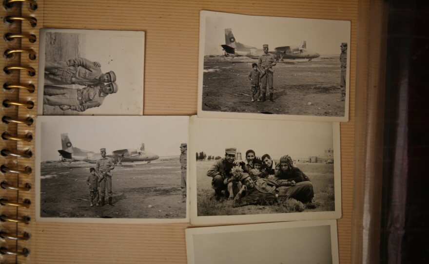 An Afghan photo studio owner and box camera photographer keeps an album with pictures he made during his years in Afghanistan's military.