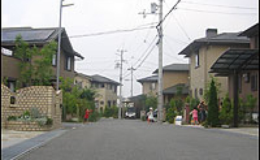 Children play in a Kobe neighborhood where all of the houses have solar panels. They are a line of energy-efficient homes designed by the electronics company Panasonic.