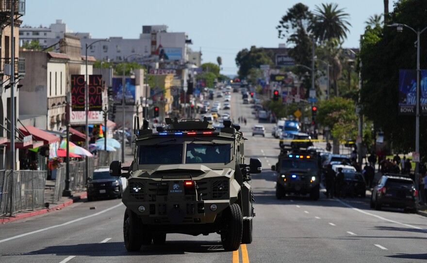 Law enforcement vehicles are seen near MacArthur Park after federal authorities made arrests on charges related to selling illicit drugs on Wednesday, May 6, 2026, in Los Angeles.