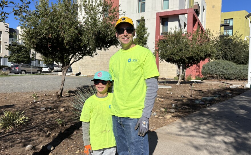 Noah Malkin (left) and his father, Oliver Malkin, gather for a photo near the newly replanted area on Dec. 6, 2025.