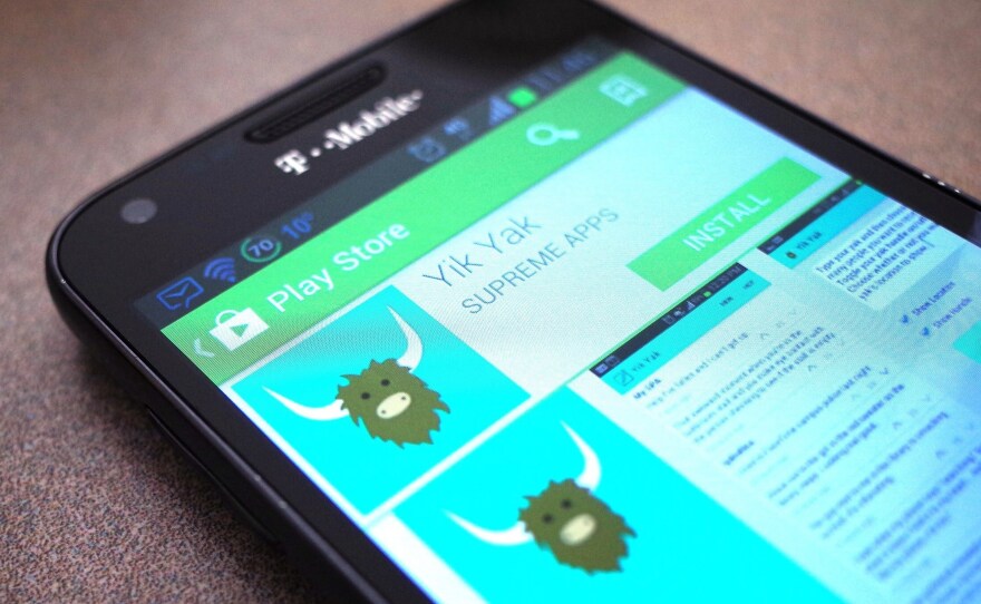 A March 28, 2014, photo illustration shows the Yik Yak app in the Google Play store. A new version is only available currently in the Apple app store in the U.S.