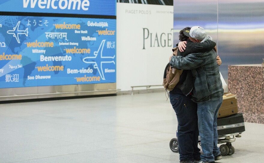 Abdullah Alghazali, right, hugs his 13-year-old son Ali Abdullah Alghazali after the Yemeni boy stepped out of an arrival entrance at John F. Kennedy International Airport in New York, Feb. 5, 2017.