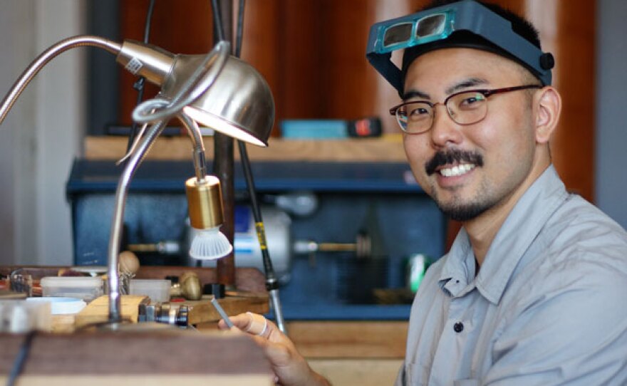 Artist Shane Yamane, shown working at his bench, combines traditional techniques with modern technology to create his precious jewelry.