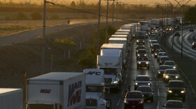  In this April 9, 2019, file photo, trucks wait to cross the border with the U.S. in Ciudad Juarez, Mexico. In a surprise announcement that could compromise a major trade deal, President Donald Trump announced Thursday that he is slapping a 5% tariff on all Mexican imports to pressure the country to do more to crack down on the surge of Central American migrants trying to cross the U.S. border.