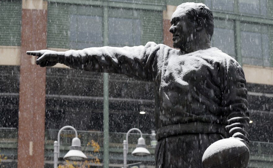 The Curly Lambeau statue at Lambeau Field in Green Bay, Wis., gets coated in snow on Monday.