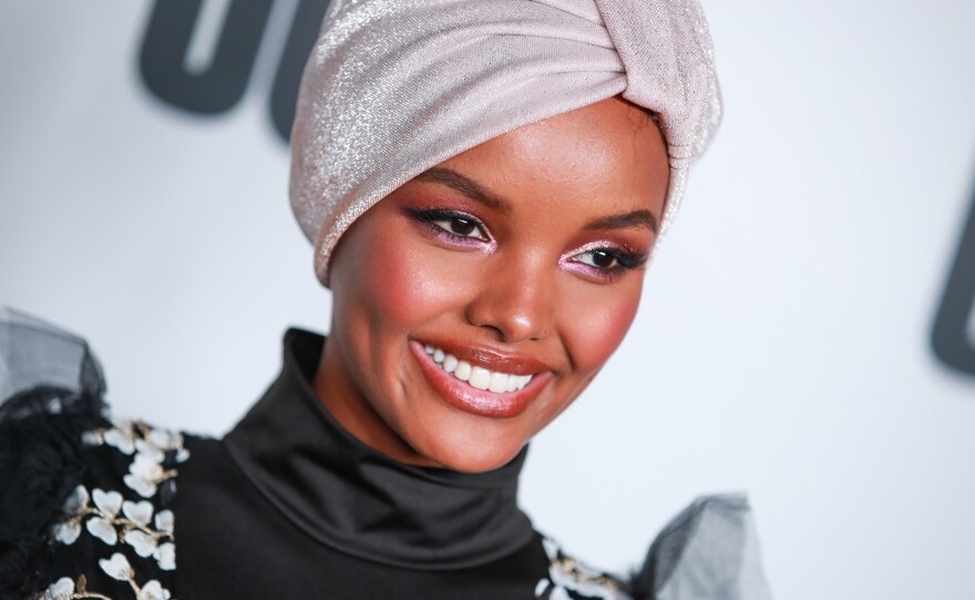 Somali American and Muslim model Halima Aden wears a burkini for Sports Illustrated's swimsuit issue, sparking both praise and criticism on social media.