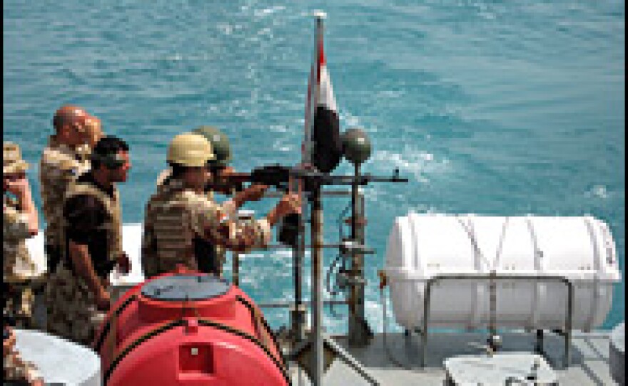 Iraqis undergo machine-gun training on the water.