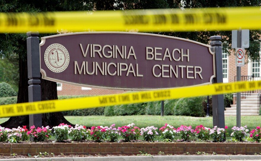 Police tape frames a sign at one of the entrances to the municipal government complex where a dozen people were shot to death earlier this year in Virginia Beach, Va.