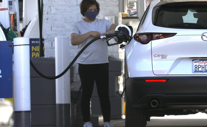 A customer pumps gas into her car at a Shell station on Oct. 12 in San Francisco. Prices for all kinds of things, including gas and food, have surged during the pandemic.
