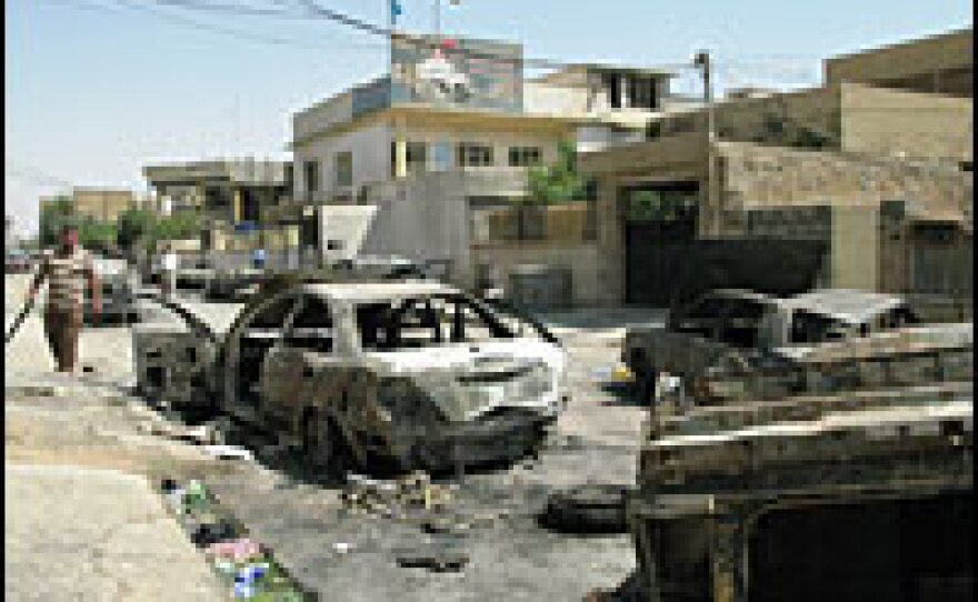 Burned-out cars remain in front of the damaged Turkman Front political headquarters in Kirkuk. The office was attacked last month by Kurdish demonstrators who believed the Turkmen were responsible for a suicide bombing at their protest.