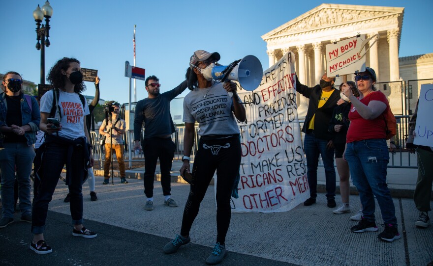 Abortion rights demonstrators chant during a protest outside the Supreme Court on Tuesday.