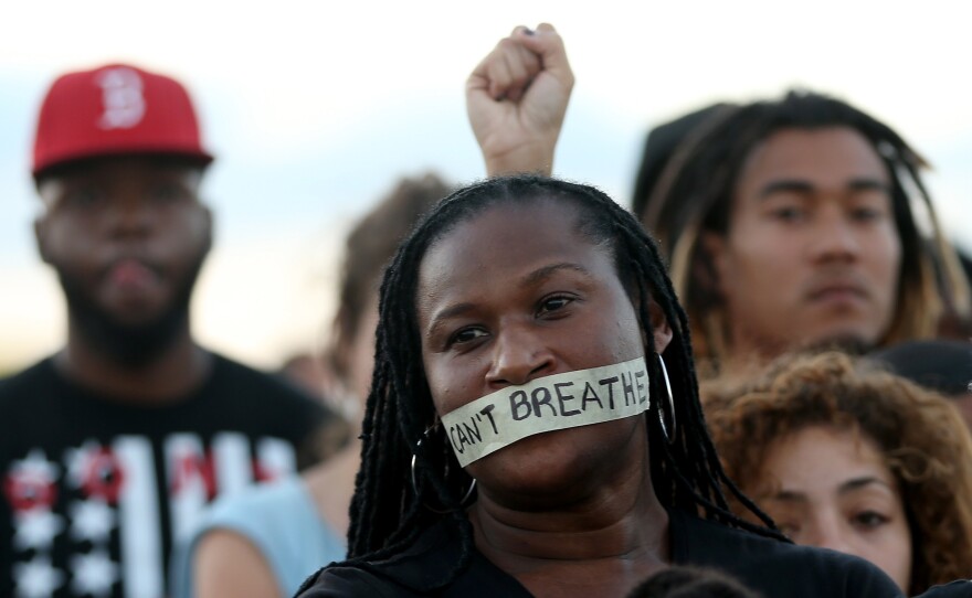 Demonstrators in Miami stand with tape reading, " I Can't Breathe," in 2014. The protest occurred after a grand jury in New York City declined to indict the police officers involved Eric Garner's death.