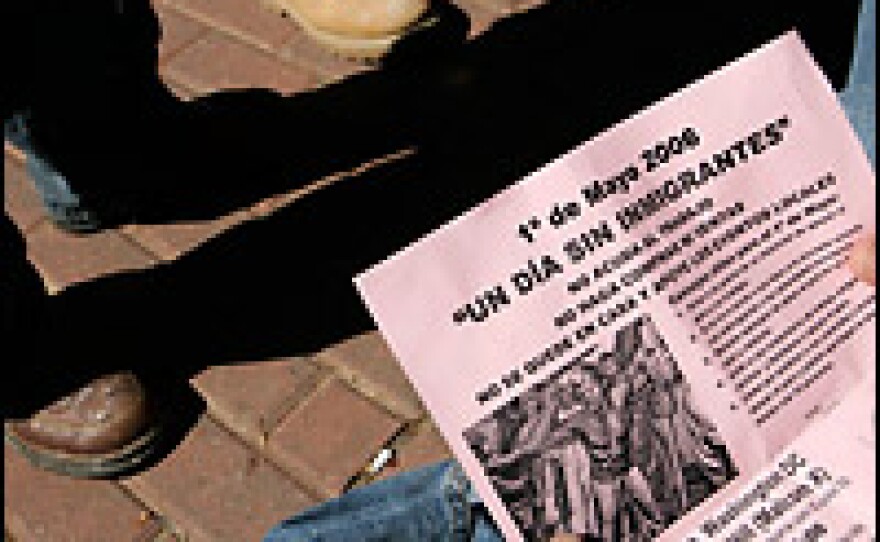 A Latino day laborer reads a May 1 boycott flyer handed out in Annandale, Va., on Saturday by community organizer Arnoldo Borja.