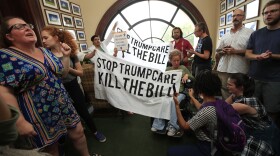 Protesters agains the Republican health care bill gather inside the office of Sen. Rob Portman, R-Ohio, on Capitol Hill in Washington, Monday, July 17, 2017.