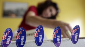 Poll worker Melanie Withey attaches "I voted" stickers to a box at a polling station on election day in San Diego, June 8, 2010.