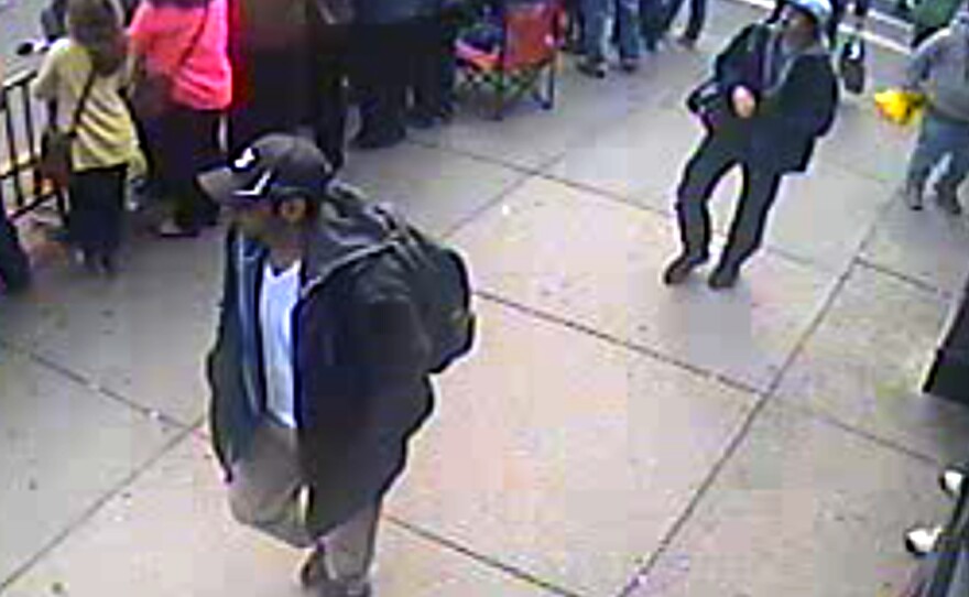Surveillance video released by the FBI showed two young men, who authorities later identified as Tamerlan Tsarnaev (in black cap) and his brother, Dzhokhar (in white cap), at the scene shortly before the Boston Marathon bombings.
