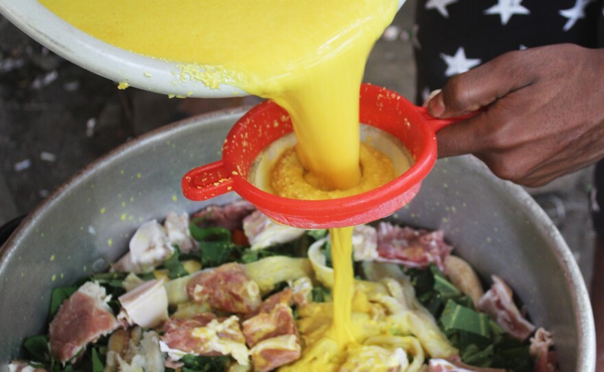 Turmeric — known locally as saffron — is mixed into coconut milk and poured over meat in the oil down pot.