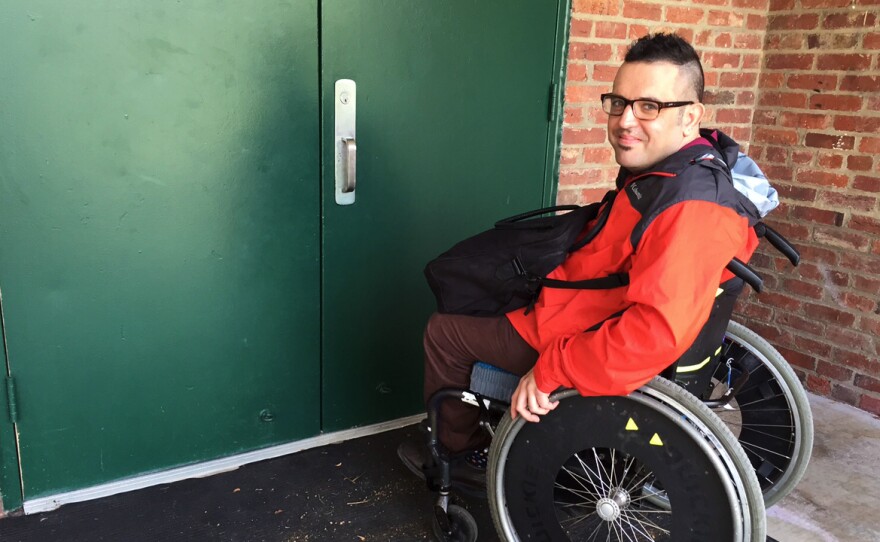 Ian Watlington, with the National Disability Rights Network, pauses at the doorway of a Washington, D.C., recreation center used as a polling place. He says the door, which has a stationary bar down the middle, would be too narrow for him to enter if he was in his motorized wheelchair. He can barely get through in his manual chair.