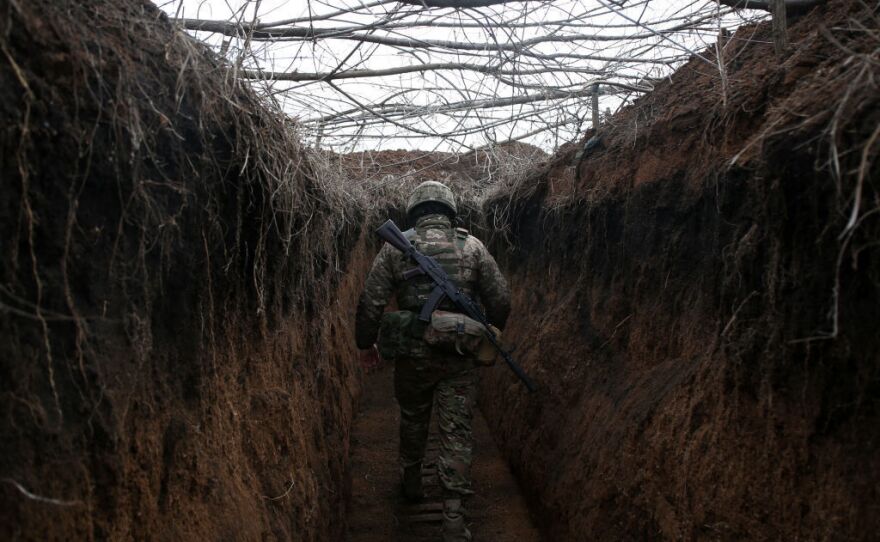 A serviceman of Ukrainian Military Forces walks along a  trench on the front line with Russia-backed separatists not far from Novolugansk, Donetsk region, on Feb. 16.