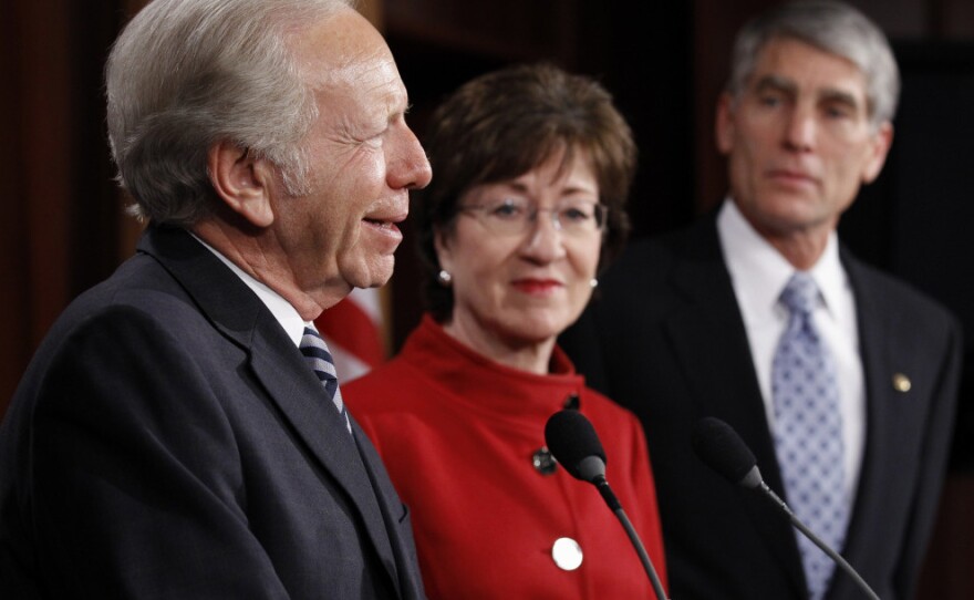 Sen. Joseph Lieberman (I-CT), with Sen. Susan Collins (R-ME) and Sen. Mark Udall (D-CO), talks about the passage of legislation to repeal "don't ask, don't tell" at the Capitol on Saturday.