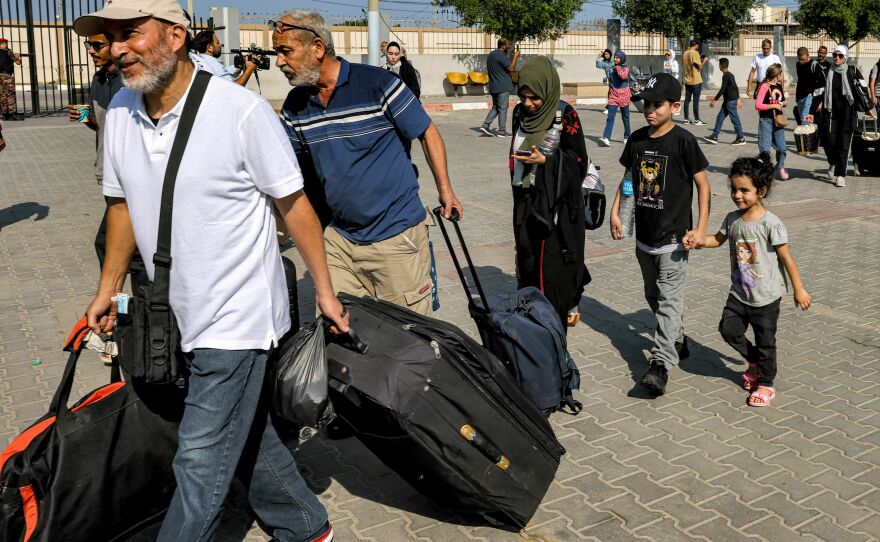 People enter the Rafah border crossing in the southern Gaza Strip before crossing into Egypt on Nov. 1, 2023.