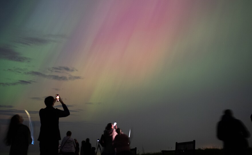 People visit St Mary's lighthouse in Whitley Bay to see the aurora borealis on Friday in Whitley Bay, England.